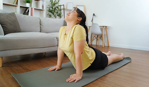 Person doing a bodyweight squat in casual home clothing
